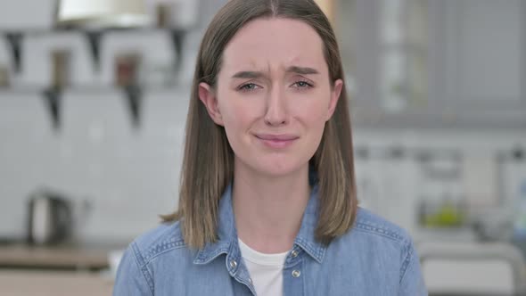 Portrait of Upset Young Woman Crying at the Camera 