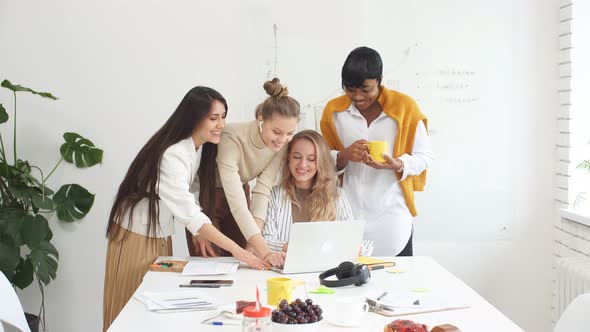 Creative Multi-ethnic Group of Managers Work Together on Laptop