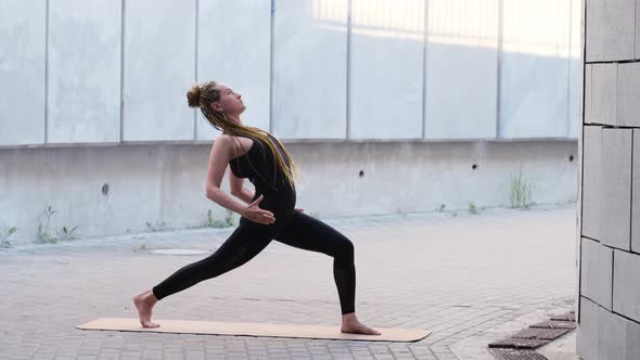 Young Woman in Yoga Facing Dog Pose