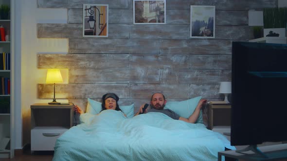 Young Couple Under the Sheets in Their Bedroom