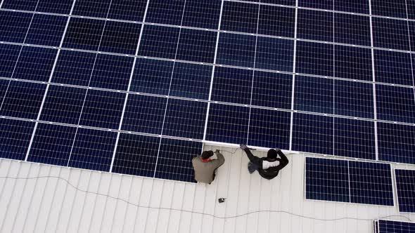 Solar Technician Installing Solar Panels on House Roof