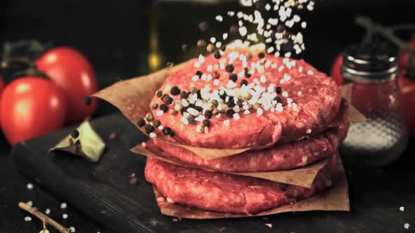 Super Slow Motion on a Bunch of Raw Burger Drops Pepper and Salt