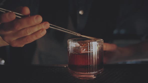 Bartender Prepares a Cocktail at the Bar