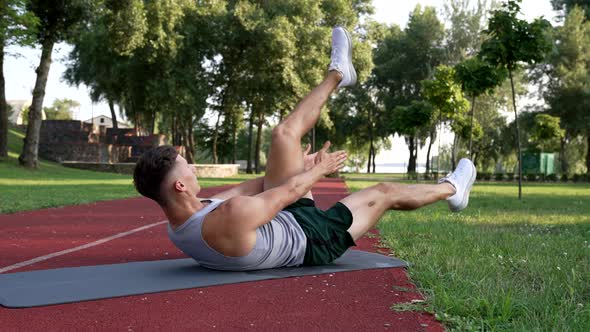 Sportsman Working on His Sixpacks with Claps on Fitness Mat Outdoor Sport Success