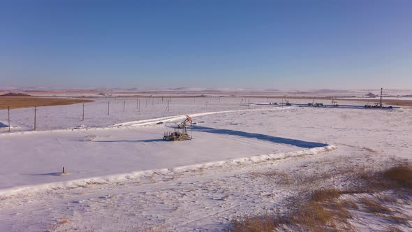 Pump Jack in Vast Oil Fields in Winter