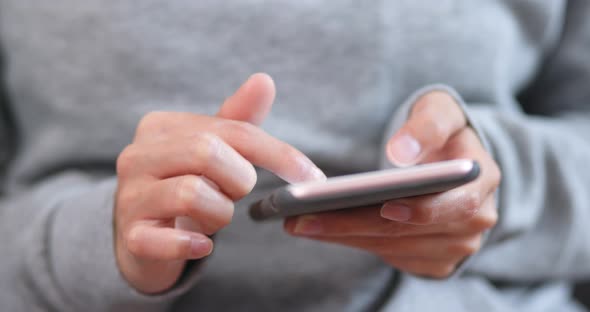 Body part of woman using cellphone