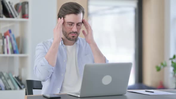 Man in Glasses with Laptop Having Headache
