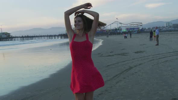 Evening view of a girl spinning on the beach