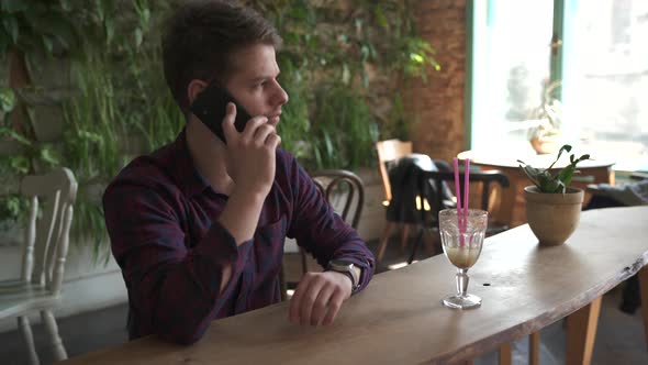 Talking on the phone inside a coffeehouse