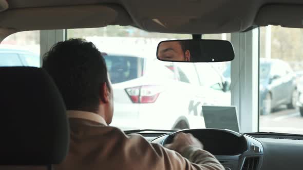 A Happy Man Is Preparing To Make His First Trip on a New Car