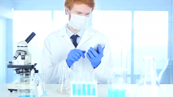 Scientist Using Smartphone in Laboratory alt