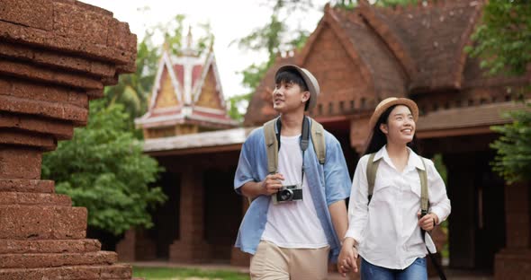 Couple hand together while visiting at ancient temple