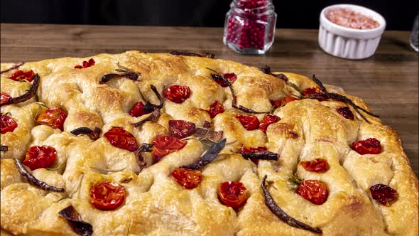 Traditional Italian Focaccia with pepperoni, cherry tomatoes, black olives, rosemary ando onion - ho