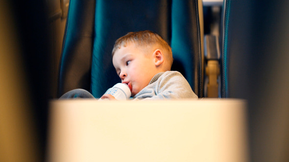 Boy In The Train Drinking Milk From The Bottle