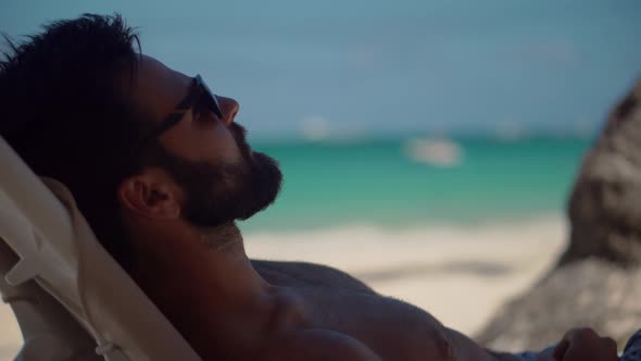 Summer Sunbathing Resort Sea Or Ocean. Beautiful Man Lies On Sunbed On Vacation.Lying On Sun Lounger