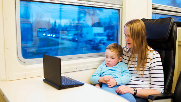 Mother And Her Son Watching Movie On Laptop alt