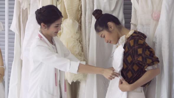 Future Bride Customer Talking with Wedding Store Shopkeeper