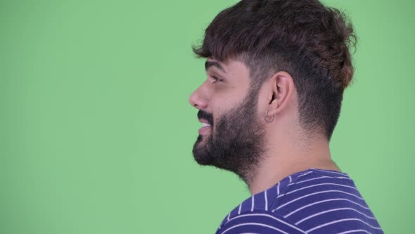 Closeup Profile View of Happy Young Overweight Bearded Indian Man Talking