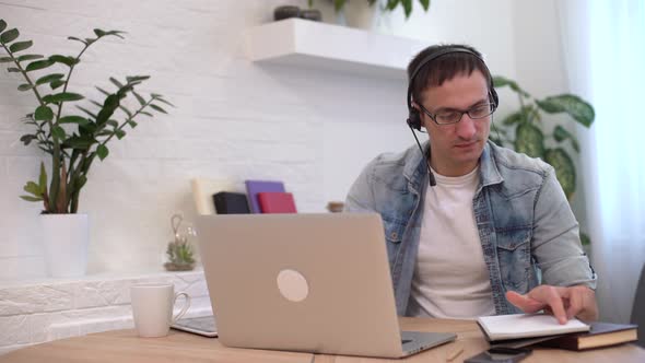 Head Shot Millennial Guy Sit in Living Room Makes Video Call Looks at Camera Conversation