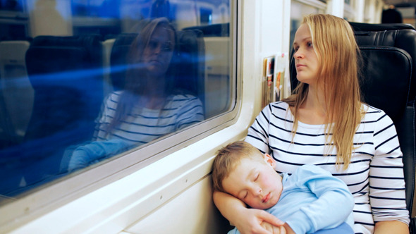 Woman Looking Out The Train Window With Her Son