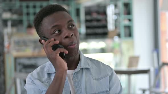 Smiling African Man Talking on Smartphone