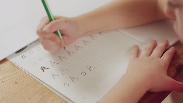 Little girl preparing her English homework