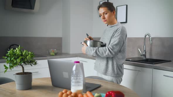 Woman Looking Recipe Online While Cooking