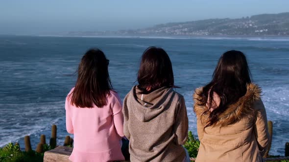 group of three women looking at the sea, pichilemu, punta de lobos Chile