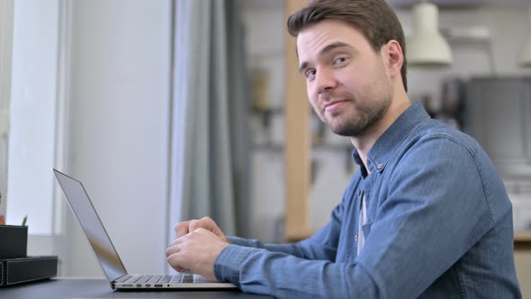 Beard Young Man Pointing Finger at Camera in Office