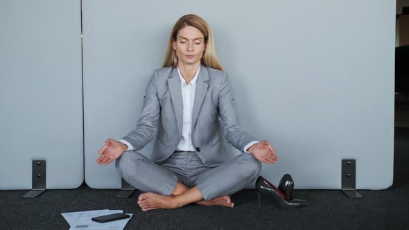 Stressful Woman in Lotus Position Sit on the Floor Closed Eyes Meditating