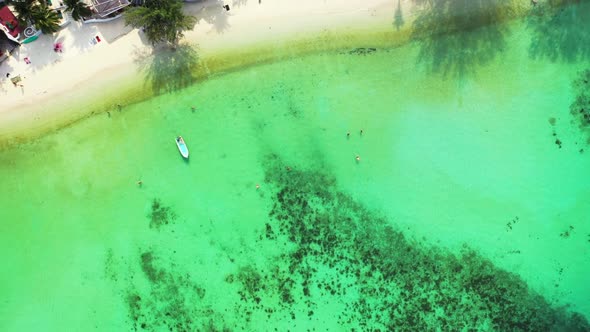 Aerial flying over panorama of perfect shore beach adventure by blue sea with white sand background 