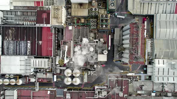 cenital dron shot of beer factory at the morning with water steam