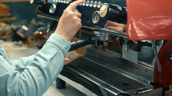 Making a cup of strong coffee in a coffee machine, the back light illuminates the steam and the cup.