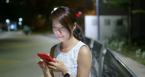 Asian Woman Use of Mobile Phone in The Park at Night