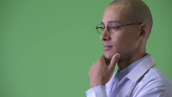 Closeup Profile View of Happy Bald Multi Ethnic Man Doctor Thinking