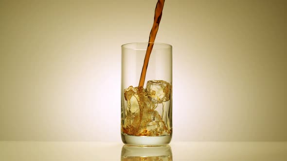 Slo-motion cola poured in a glass
