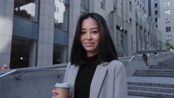 Portrait of a Young Adult 20s Asian Woman Enterpreneur Looking at Camera in Downtown