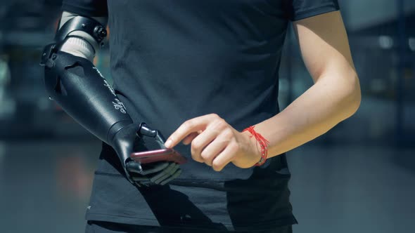 Man Typing with Bionic Prosthesis. Cyborg Concept