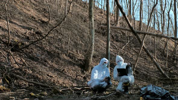 Forensic specialists working in the forest. Crime scene and police concept.