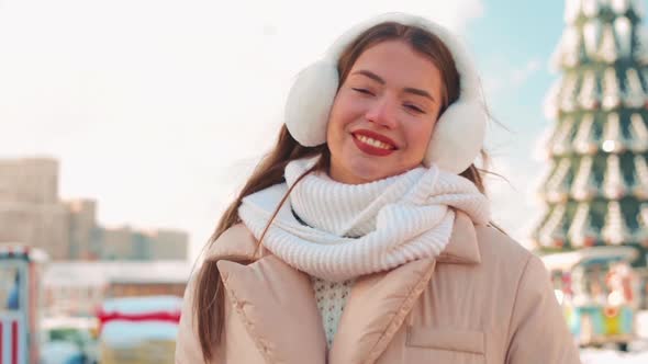 Young Woman Dressed Fur Earmuff and White Knitted Scarf Standing Outdoor Winter Season on City