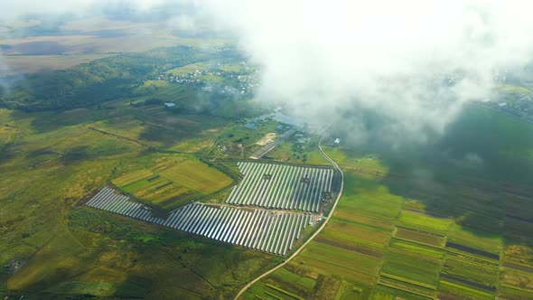 Aerial View of Big Sustainable Electric Power Plant with Many Rows of Solar Photovoltaic Panels for