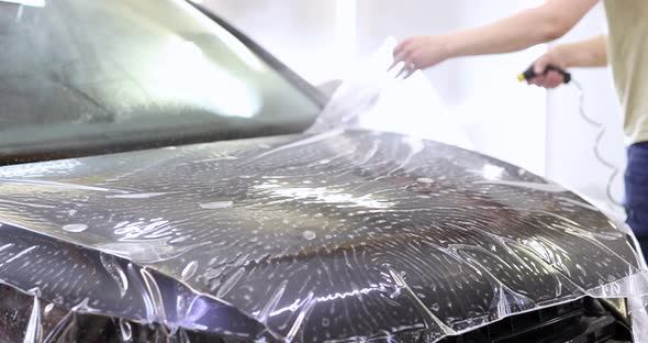 Apply Protective Film to Car Hood in Car Service Slow Motion  Movie