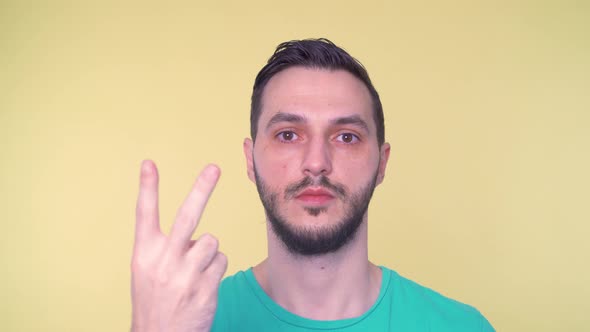 Young Man Counting on Fingers Close Up