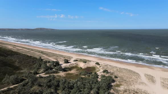 Drone Flight Over the Azure Sea with Waves and Sandy Coast