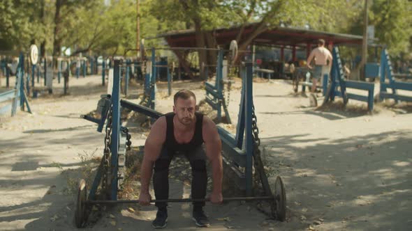 Bodybuilder Doing Weightlifting Workout Outdoors