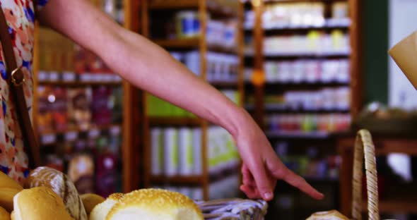 Male staff packing bread in paper bag