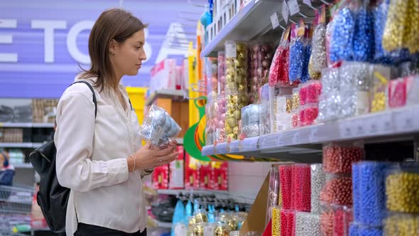 Woman Buying Christmas Decoration in the Hypermarket