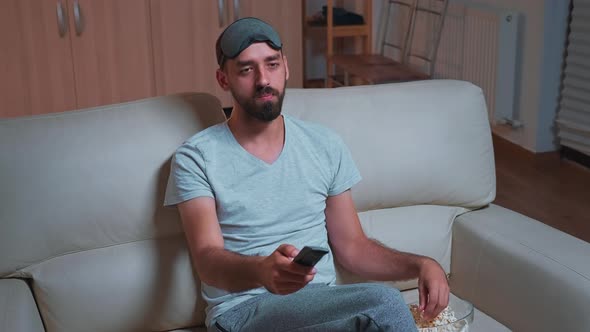 Interested Man with Beard Relaxing in Front of Television While Looking at Entertainment Movie