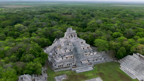 Drone flying around Mayan ruins in the middle of the jungle.