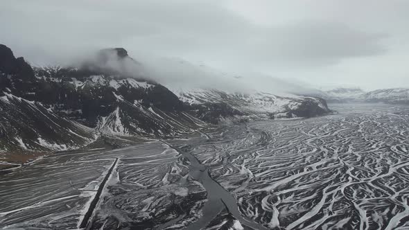 Aerial view of a river estuary along the mountain in Iceland.